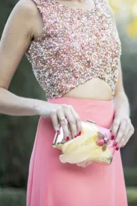 Bolso dorado con plumas amarillas y joya de insecto coral